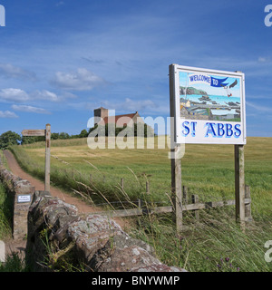 Welcome to St Abbs Sign next to Public Footpath and Field with St Abbs Church in the background, Berwickshire, Borders, Scotland