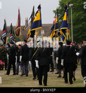 Royal British Legion members parade their standards with black ribbons flying in respect at a funeral service Stock Photo