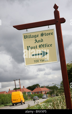 A village store & post office sign on a rural road in the U.K. Stock Photo