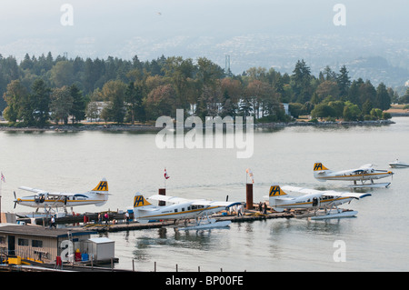 A high angle view of four Harbour Air seaplanes (de Havilland Canada DHC-3T ) in Coal Harbour, Vancouver, Canada. Stock Photo