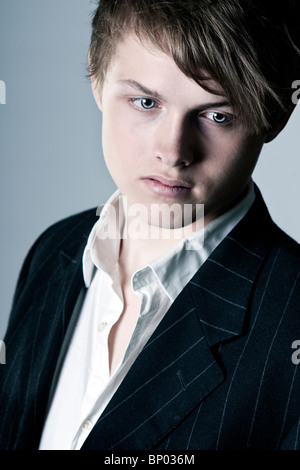 Shot of a Handsome Teenage Boy in Suit and Shirt Stock Photo