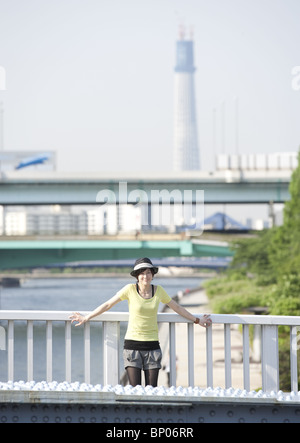 Young woman standing on bridge Stock Photo