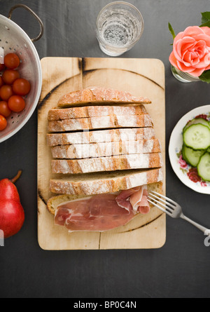 Bread on wooden board with ham Stock Photo