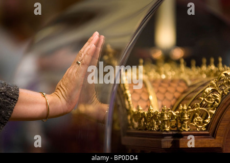 A Worshipers places her hand on the relics of Saint Therese of Lisieux  at St John's Catholic Cathedral in Portsmouth. Stock Photo