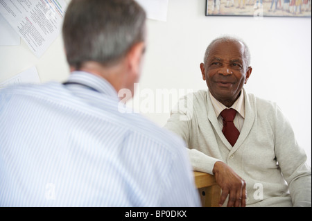 Elderly black man talking to doctor Stock Photo