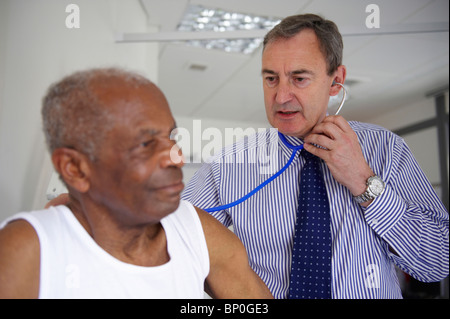 Doctor with stethoscope with elderly man Stock Photo