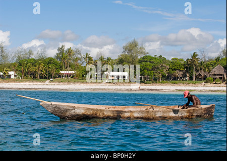 Kenya, Coast, Diani Beach. A fisherman in his dugout canoe. Stock Photo