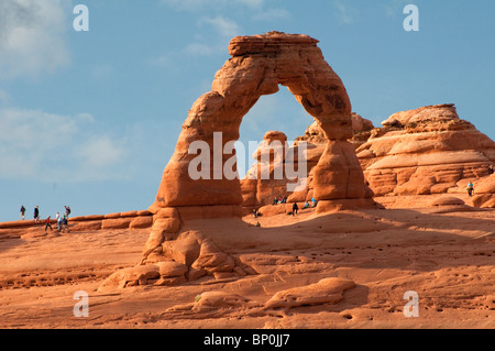 Tourists watching Delicate Arch at sunset. Arches National Park, Utah. USA Stock Photo