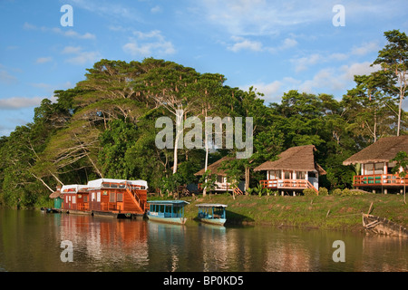 Peru. A tourist Lodge and two houseboats on the banks of the Madre de Dios River. Stock Photo