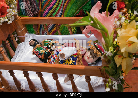 Peru, The Andean version of Baby Jesus, Nino Manuelito, is carried in cot by dancers during Christmas Day celebrations Stock Photo