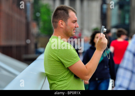 Tourist in London taking a picture with his digital compact camera Stock Photo