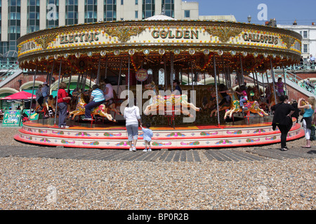 Electric Golden Gallopers merry-go-round on Brighton Beach, Sussex, England. Stock Photo