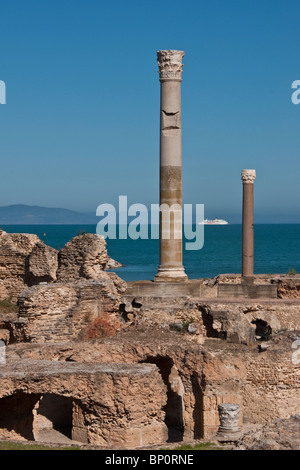 Carthage ruins of Antonine Baths at Tunis with Tunisia Ferries ship on Mediterranean Sea in background Stock Photo