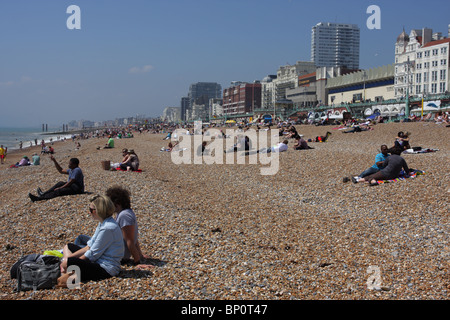 Bank Holiday tourists and locals enjoying beautiful weather on Brighton beach. Stock Photo