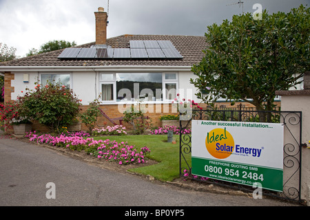 PV solar panels on house of small bungalow Cheltenham UK Stock Photo