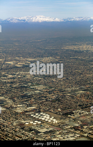 aerial view above across Los Angeles basin smog to snow covered San Gabriel mountains California Stock Photo