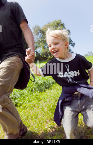 Man and boy running down a hill Stock Photo