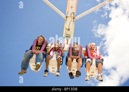Four boys on a thrill ride at Cobleskill Sunshine Fair, New York State Stock Photo