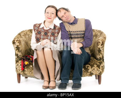 old looking couple in love sitting on retro couch Stock Photo