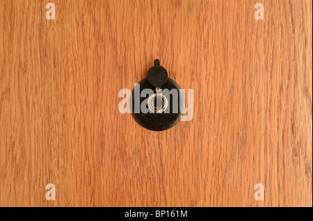 The spy hole on wooden doors Stock Photo