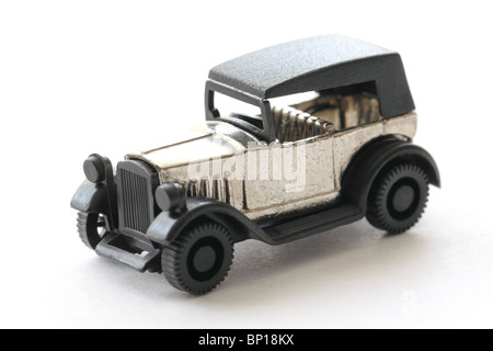Close-up photograph of a one-inch black and silver toy car isolated on a white background. Stock Photo
