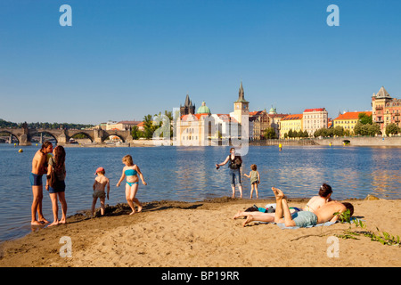 prague - people enjoying summer strelecky island beach - old town in ...