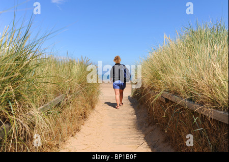 Walking through sand dunes along the North Norfolk coast UK near the Titchwell Marsh RSPB nature reserve Stock Photo