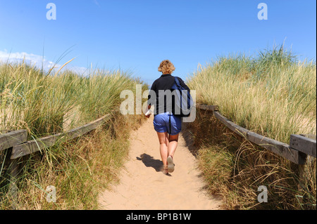 Walking through sand dunes along the North Norfolk coast UK near the Titchwell Marsh RSPB nature reserve Stock Photo