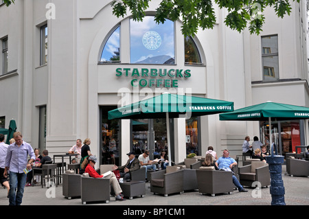 People sitting at a Starbucks coffee shop Kurfurstendamm Berlin Germany July 2010 Stock Photo