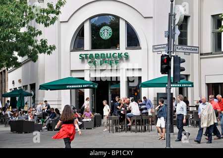 People sitting at a Starbucks coffee shop Kurfurstendamm Berlin Germany July 2010 Stock Photo