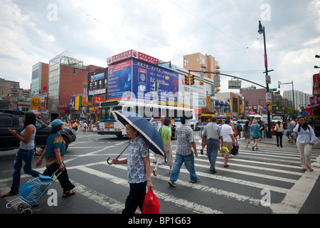 The busy intersection of Main Street and Roosevelt Avenue in the neighborhood of Flushing in the borough of Queens in New York Stock Photo