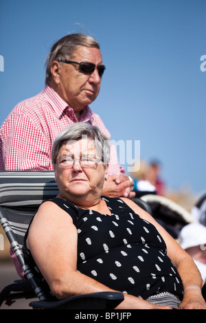 Bored senior couple sitting down. Stock Photo