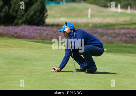 Male player from the Italian under 18 boys golf team , lining up a put at Kilmarnock Barassie Golf course, Troon, Ayrshire, Scotland Stock Photo