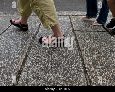 People walking on a pavement. Stock Photo