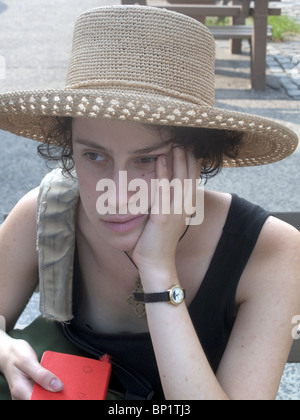 Serious looking young woman deep in thought Stock Photo