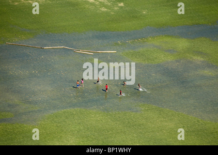 Children Playing on Flooded Sports Field, Vitacura, Santiago, Chile, South America - aerial Stock Photo