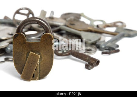 Old padlock and heap of keys isolated on white Stock Photo
