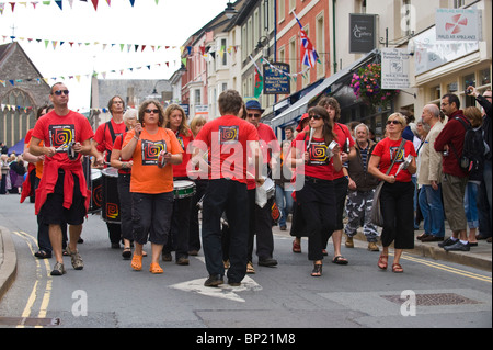 Samba Galez community drumming band parade through streets of Brecon town during Brecon Jazz Festival 2010 Stock Photo