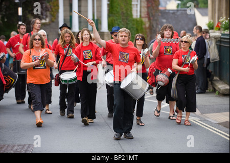 Samba Galez community drumming band parade through streets of Brecon town during Brecon Jazz Festival 2010 Stock Photo