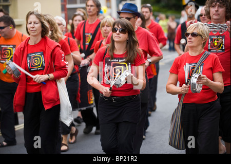 Samba Galez community drumming band parade through streets of Brecon town during Brecon Jazz Festival 2010 Stock Photo