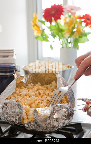 Popping Corn in Foil Pan at Home, Series, 4 of 6 Stock Photo