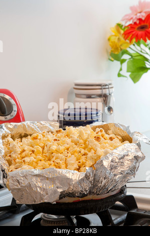 Making popcorn with an electric popper at home Stock Photo - Alamy