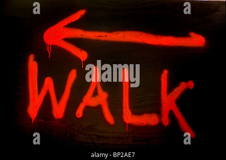 Red painted walk sign on a building site directing pedestrians on 42nd Street, Manhattan, New York City. Stock Photo