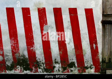 Red and white striped warning colours painted on a wall in Vincenza, Italy Stock Photo