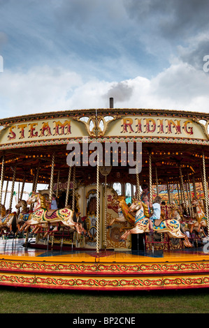 Steam Galloping horse carousel, fairground ride at a  steam fair in England Stock Photo