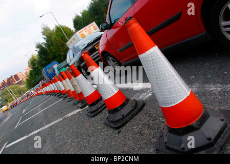 UK, England, Cheshire, Stockport traffic delayed in roadworks with cones blocking one lane Stock Photo