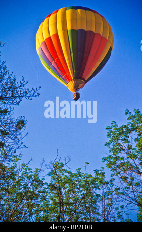 Hot air balloon riders soar , float over Lancaster farm fields, copy space Stock Photo