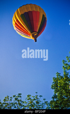 Hot air balloon riders soar , float over Lancaster farm fields, early morning. copy space Stock Photo