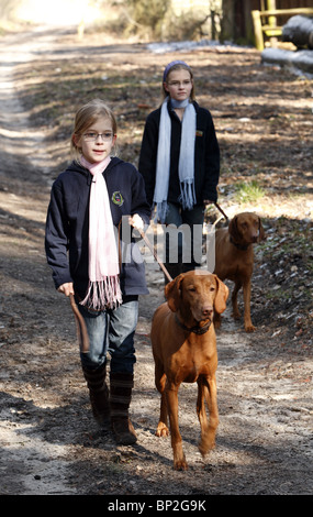 Two sisters walking their dogs in the forest, Hamburg, Germany Stock Photo