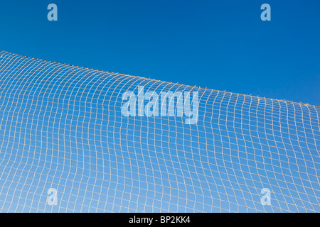 pattern created by string netting against a blue sky Stock Photo